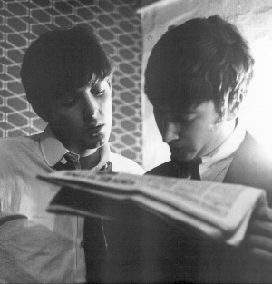 Paul and John reading the news